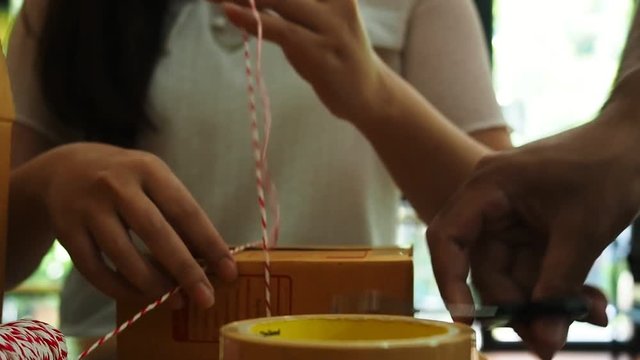 Business owner work at home wrapping parcel box, Alpha generation life style. Business woman entrepreneurial successful. Sales Online Parcel delivery. New generation life style of young entrepreneur.