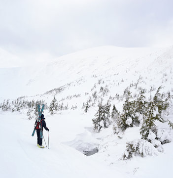 Alpine touring skier in winter mountains.