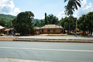 Dar es Salaam, Tanzania - July 9, 2018: House near road Man is running