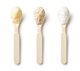 Spoon with porridge powder isolated on white, from above