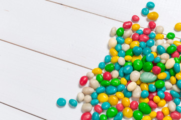 Colorful candies on wooden background