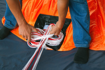 Skydiver packs the parachute before jumping.  Base jumping.