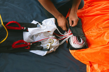 Skydiver packs the parachute before jumping.  Base jumping. - obrazy, fototapety, plakaty
