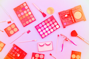 Cosmetics set for women isolated on sweet color paper background,pastel color filter style.