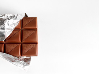 Milk chocolate on unfolded foil with copyspace