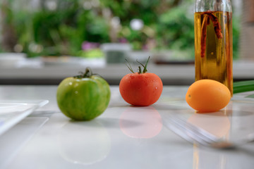 Colorful Fresh Tomatoes on white marble background with space.