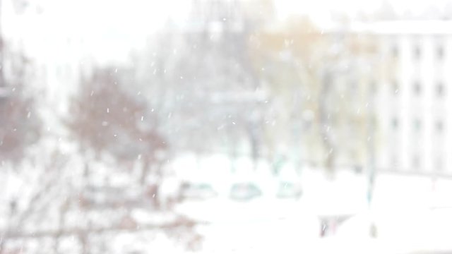 Close up of slanting snow falling in city. Blurred background of snow falling in winter. Winter season time.