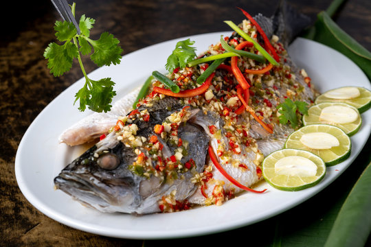 Favourite seafood of Thailand, steamed white snapper with lemon sauce.