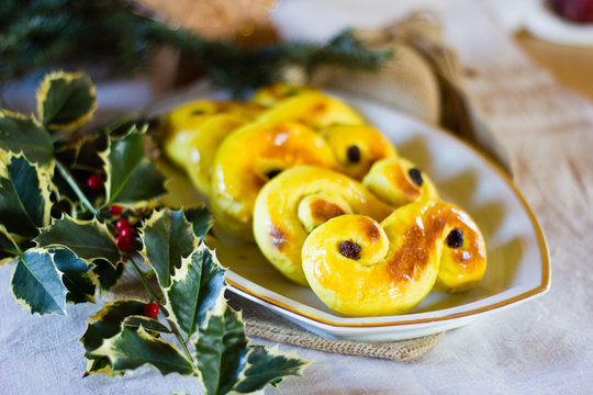 Typcial traditional Swedish saffron buns for the Christmas holidays and Ludia Day in December called "Lucia buns" or also "Lussekatter".  Selective focus
