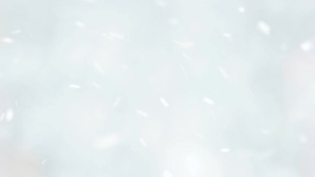 Blurred winter background. Falling snowflakes close up. Cozy winter atmosphere.