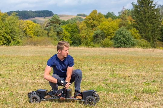 Young dutch man rides electric mountainboard off road
