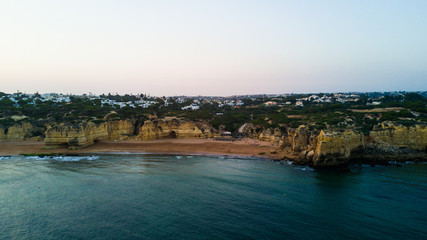 Obraz premium Aerial view of sunset over the coast Algarve coast, Portugal. Concept for above Lagos beach of Portugal. Summer vacations