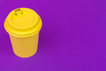 Takeaway cup of coffee on bright colored background