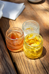 Close-up shoot of traditional sauses, ketchup, mayonnaise, mustard under clean light