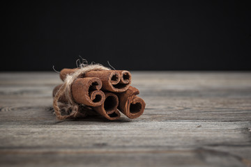 Cinnamon sticks on wooden background.