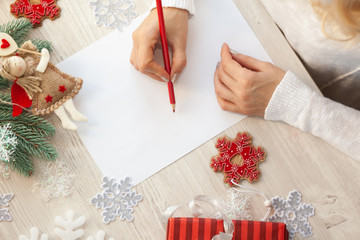 Woman writing a letter to Santa. Christms time. New Year 2019