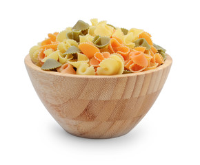 Pasta shells in a wooden bowl isolated on white