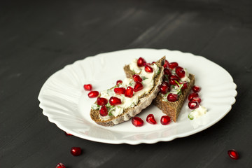 sandwich with cheese, greens and pomegranate berries
