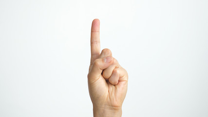 Close up of isolated female hand shows index finger up isolated on white background