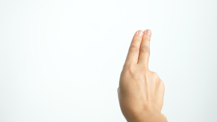 Close up of isolated female hand shows two fingers up isolated on white background