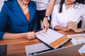 Businessmen and businesswomen discuss work at table with devices in hands isolated