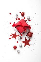 Merry Christmas and Happy Holidays greeting card. New Year. Red gift, present on white background top view. Winter holidays.