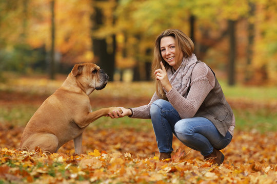 Middle Age Woman Doing Tricks With Her Dog