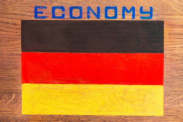 Closeup flag of Germany. Above the image of the flag inscription economy.