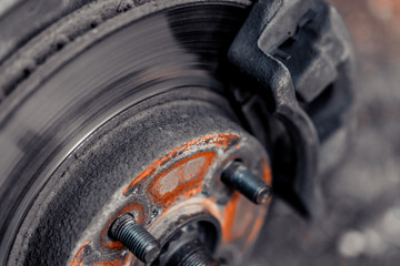 Closeup of brake disc and car wheel caliper.