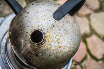 Old kettle on a pile of pots