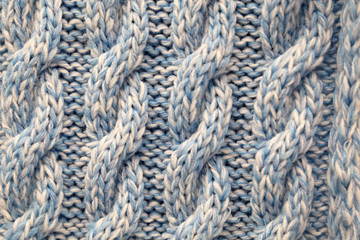 Knitted fabric with a pattern. Yarn texture background, warm clothing, crocheting concept