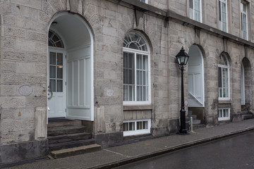 Entrances to vintage building on wet street