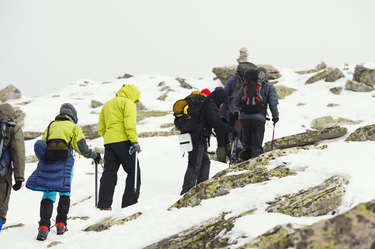 A group of climbers climbs the mountain slope.