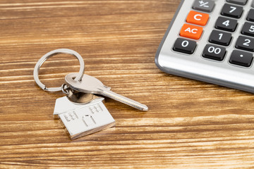 Calculator and house key concept for mortgage