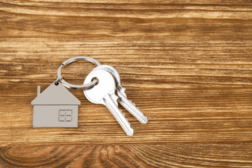 House key on wooden background concept for mortgage