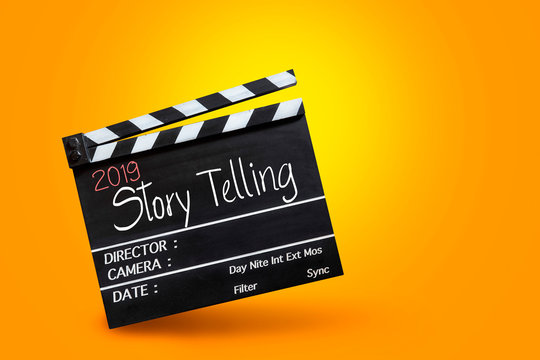 2019 story telling ,text title on movie Clapper board on orange colour backgrounds