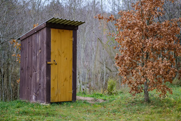 old wooden countryside toilet house with heart shaped hole in the door