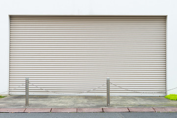 A closeup shot of automatic metal roller door used in factory, storage, garage, and industrial...