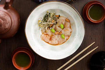 Plate with scallops and nuts in an Asian restaurant