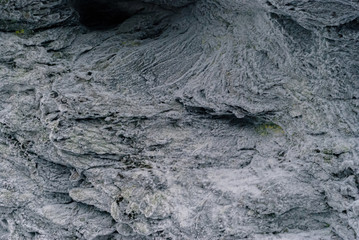 background, texture - bizarrely wrinkled surface of natural old rock, covered with frost