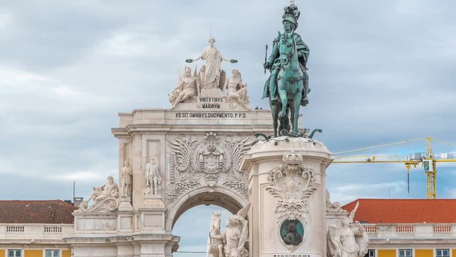 Triumphal arch at Rua Augusta and bronze statue of King Jose I at Commerce square timelapse in Lisbon, Portugal.