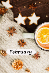 Fototapeta na wymiar Winter theme. Hot tea with spices,orange,cinnamon,anise,cookies