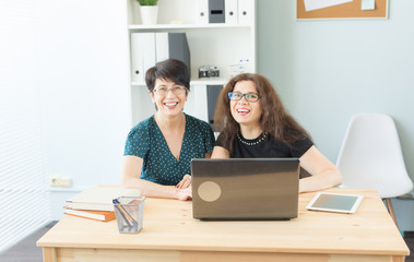 Two happy businesswoman working together in office