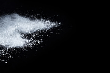 White powder isolated on black background.