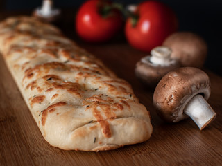 Piece of Focaccia flat oven-baked Italian bread on the table