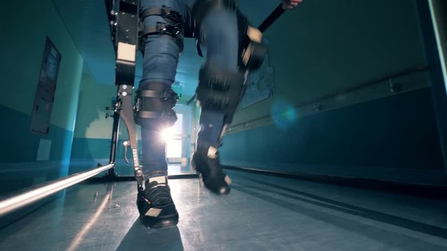 Mechanical prosthesis on a person. A man walks in a special prosthesis at a hospital.