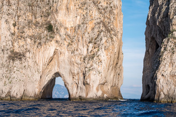 Iconic sea stacks and arch off the coast of Capri, Italy. They are named Stella, Faraglione di...