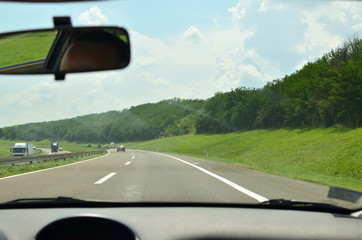 Driving on a highway that goes through beautiful countryside in summertime