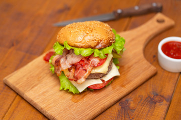 Fresh tasty burger on wood table