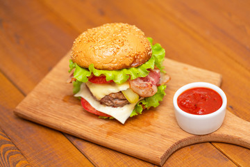 Fresh tasty burger on wood table